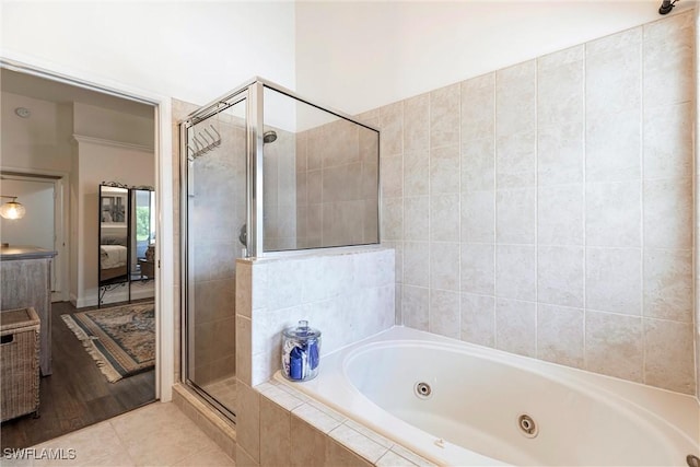 6769 Berwick Pl, Naples, FL 34104 - ensuite bathroom featuring a jetted tub, a stall shower, and tile patterned flooring