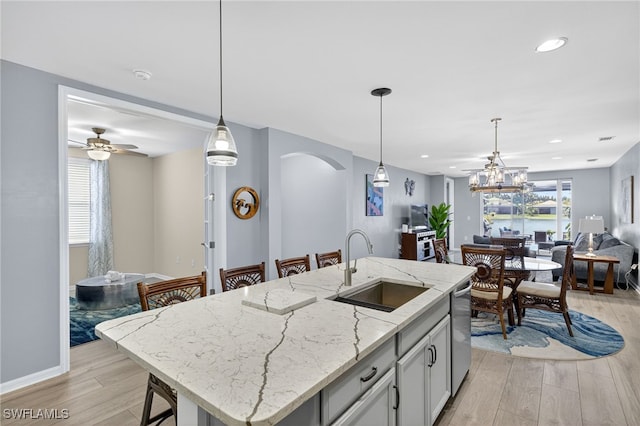 14803 Edgewater Cir, Naples, FL 34114 - kitchen with arched walkways, open floor plan, light wood finished floors, pendant lighting, and recessed lighting