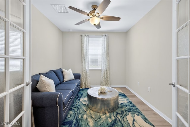14803 Edgewater Cir, Naples, FL 34114 - living area featuring french doors, light wood-style flooring, and ceiling fan