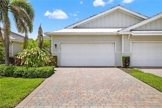 14803 Edgewater Cir, Naples, FL 34114 - view of front of house featuring board and batten siding and decorative driveway