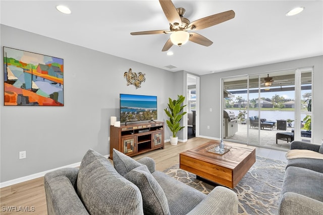 14803 Edgewater Cir, Naples, FL 34114 - living area featuring a ceiling fan, recessed lighting, and light wood-style flooring