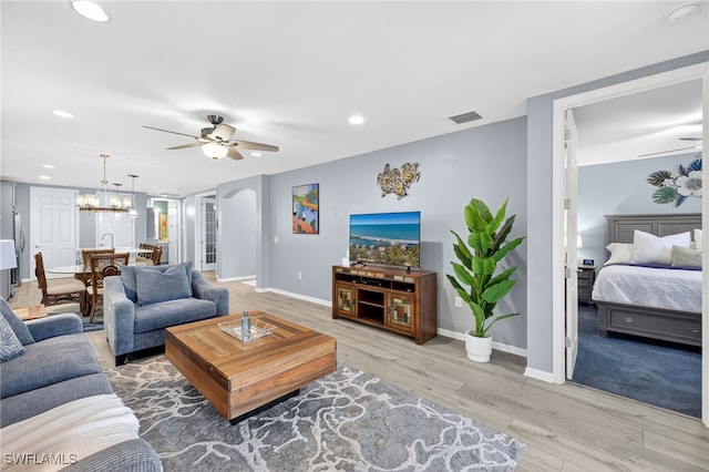 14803 Edgewater Cir, Naples, FL 34114 - living room with ceiling fan, light wood-style flooring, a chandelier, and recessed lighting