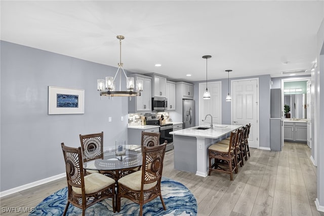 14803 Edgewater Cir, Naples, FL 34114 - dining space featuring light wood-style flooring, a chandelier, and recessed lighting