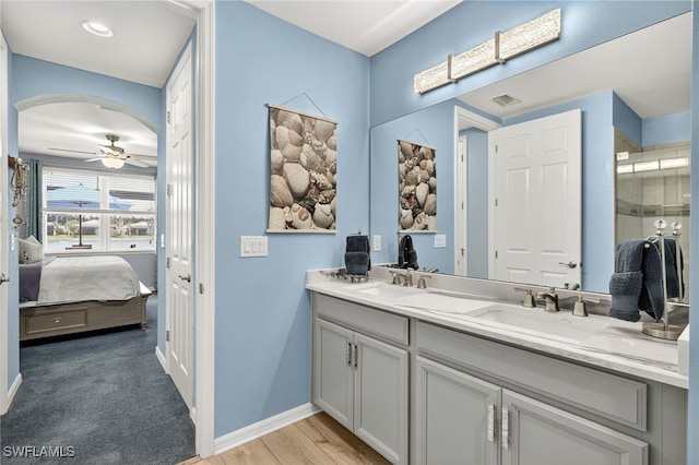 14803 Edgewater Cir, Naples, FL 34114 - ensuite bathroom featuring double vanity, a ceiling fan, and an enclosed shower
