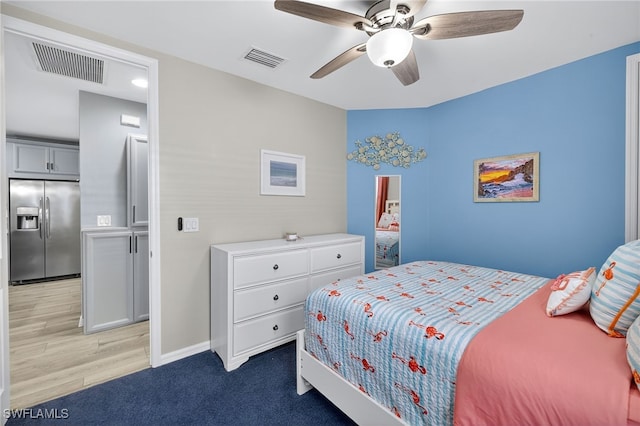 14803 Edgewater Cir, Naples, FL 34114 - bedroom with stainless steel fridge with ice dispenser, a ceiling fan, and light wood finished floors