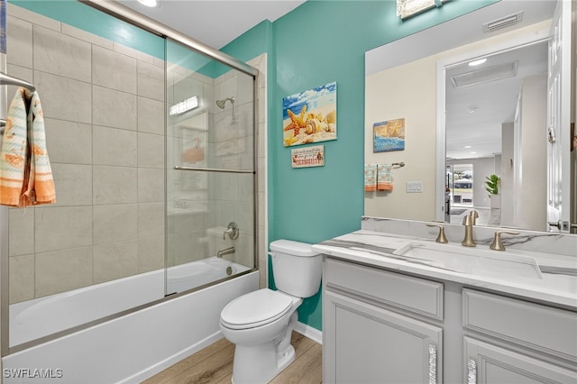 14803 Edgewater Cir, Naples, FL 34114 - full bath with vanity, wood finished floors, shower / bath combination with glass door, and recessed lighting