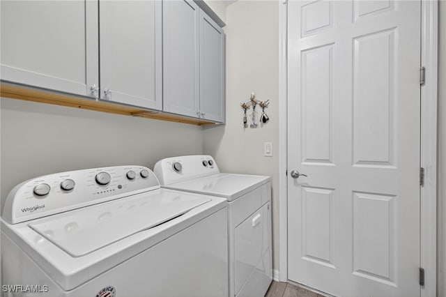 14803 Edgewater Cir, Naples, FL 34114 - laundry room with washer and dryer and cabinet space