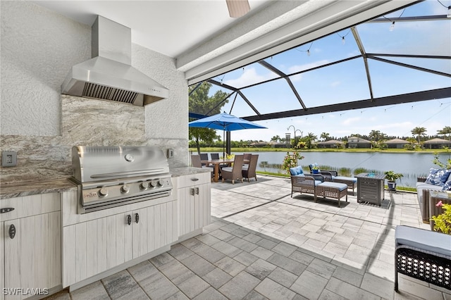 14803 Edgewater Cir, Naples, FL 34114 - view of patio / terrace featuring an outdoor hangout area, a water view, glass enclosure, outdoor dining space, and an outdoor kitchen