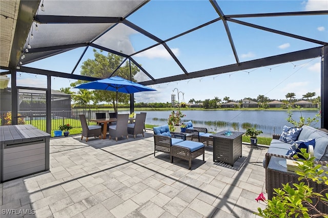 14803 Edgewater Cir, Naples, FL 34114 - view of patio with an outdoor living space with a fire pit, a water view, a lanai, and outdoor dining area