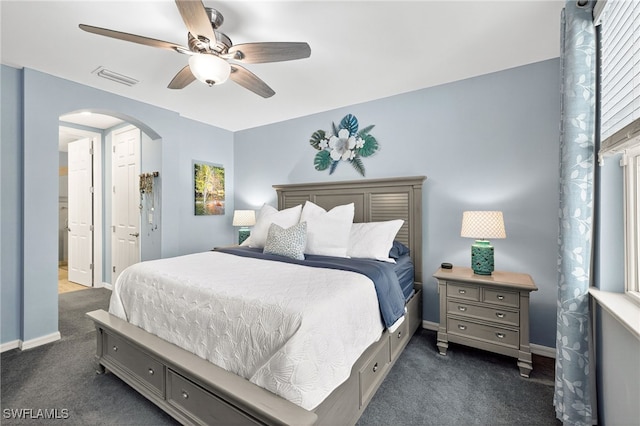 14803 Edgewater Cir, Naples, FL 34114 - bedroom featuring dark colored carpet, arched walkways, and multiple windows