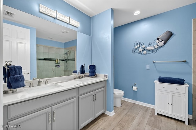 14803 Edgewater Cir, Naples, FL 34114 - bathroom with double vanity, a stall shower, and wood finished floors