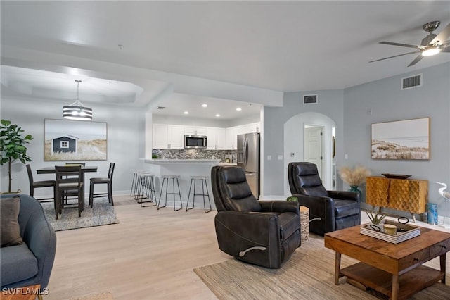 3948 Pomodoro Cir Unit 102, Cape Coral, FL 33909 - living area with arched walkways, ceiling fan, light wood-style floors, and recessed lighting