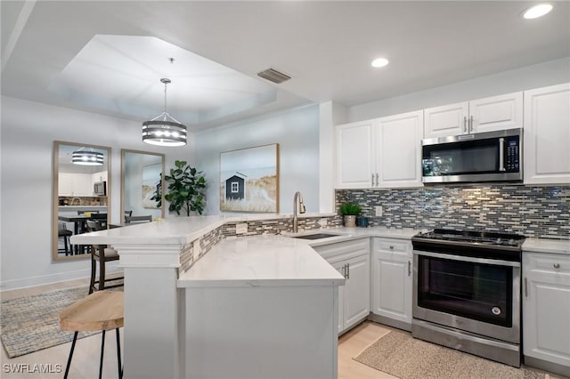 3948 Pomodoro Cir Unit 102, Cape Coral, FL 33909 - kitchen with stainless steel appliances, a peninsula, recessed lighting, backsplash, and light countertops