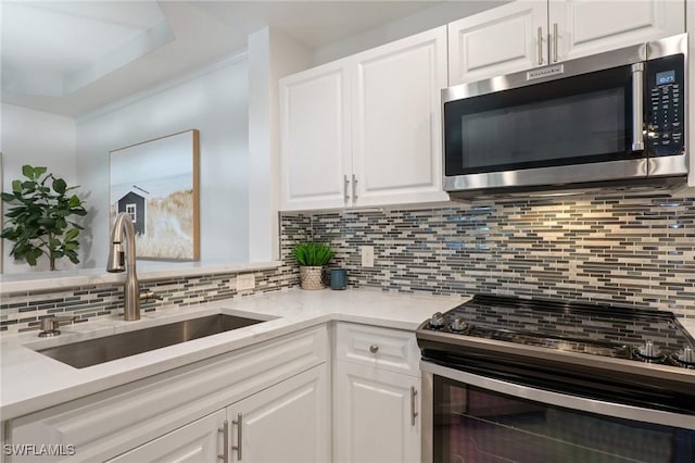 3948 Pomodoro Cir Unit 102, Cape Coral, FL 33909 - kitchen with stainless steel appliances, white cabinets, backsplash, and light countertops
