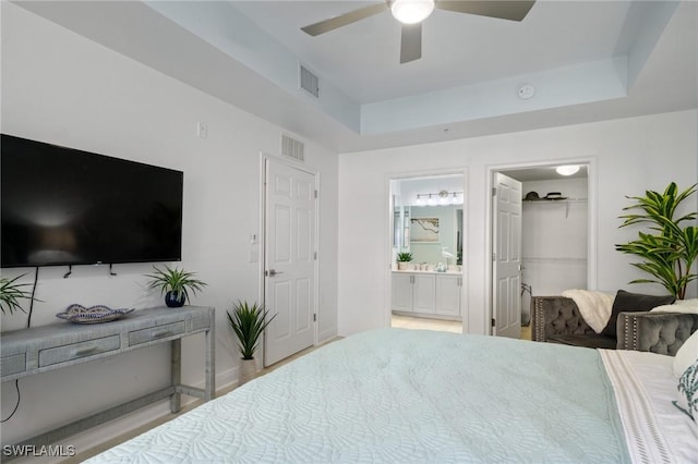 3948 Pomodoro Cir Unit 102, Cape Coral, FL 33909 - bedroom with a spacious closet, ensuite bathroom, a ceiling fan, and a closet