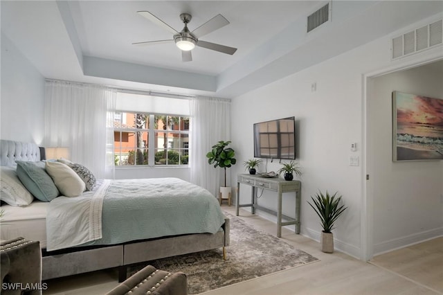3948 Pomodoro Cir Unit 102, Cape Coral, FL 33909 - bedroom featuring a tray ceiling, light wood-style floors, and ceiling fan