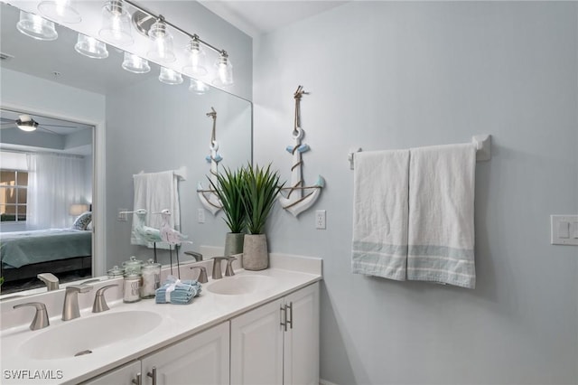 3948 Pomodoro Cir Unit 102, Cape Coral, FL 33909 - bathroom with connected bathroom, double vanity, and ceiling fan