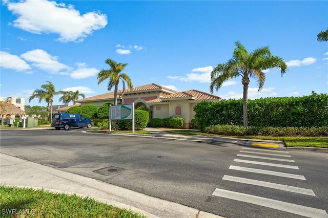 3948 Pomodoro Cir Unit 102, Cape Coral, FL 33909 - view of front facade with a tile roof, stucco siding, and uncovered parking