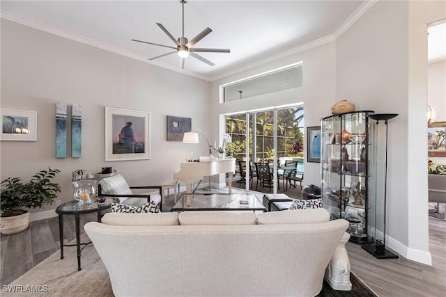 4372 Bittern Ct, Naples, FL 34119 - living area with ceiling fan, wood finished floors, crown molding, and a towering ceiling
