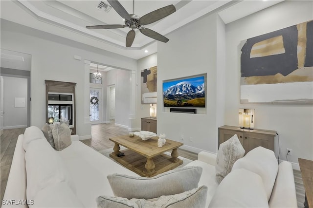 10082 Palazzo Dr, Naples, FL 34119 - living room featuring wood finished floors, ceiling fan, a tray ceiling, and recessed lighting