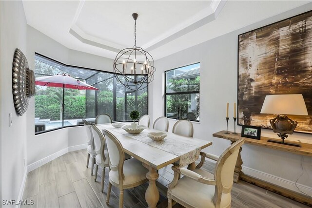 10082 Palazzo Dr, Naples, FL 34119 - dining area with a chandelier and a raised ceiling