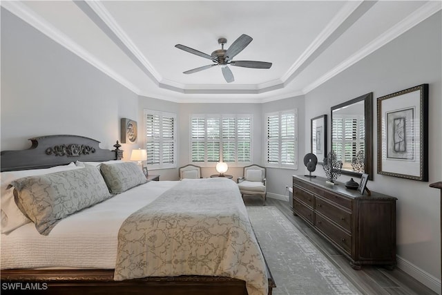 10082 Palazzo Dr, Naples, FL 34119 - bedroom with a tray ceiling, ornamental molding, a ceiling fan, and wood finished floors