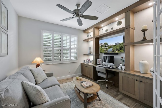 10082 Palazzo Dr, Naples, FL 34119 - office space with built in study area, light wood finished floors, and a ceiling fan