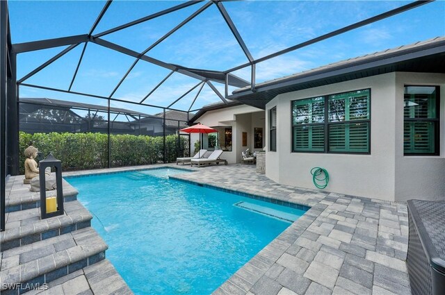 10082 Palazzo Dr, Naples, FL 34119 - swimming pool with a patio area and glass enclosure