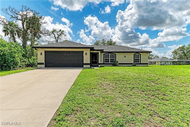 5482 Globe Ter, North Port, FL 34286 - single story home featuring stucco siding, a garage, concrete driveway, and a front yard