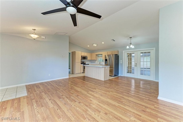 5482 Globe Ter, North Port, FL 34286 - unfurnished living room featuring french doors, light wood-type flooring, vaulted ceiling, ceiling fan, and a chandelier