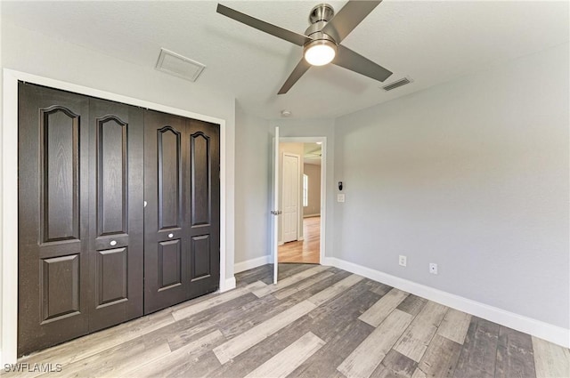 5482 Globe Ter, North Port, FL 34286 - unfurnished bedroom featuring light wood-style flooring, a closet, and a ceiling fan