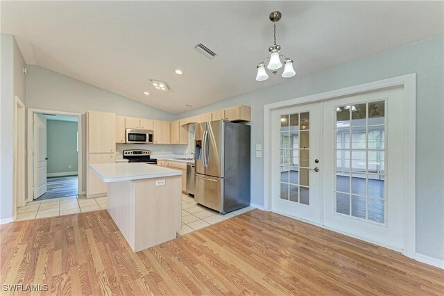 5482 Globe Ter, North Port, FL 34286 - kitchen with appliances with stainless steel finishes, light brown cabinetry, french doors, light countertops, and light wood-type flooring