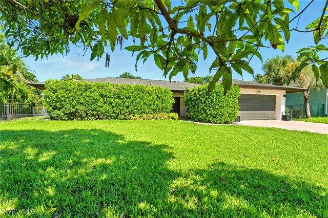 2491 43rd St SW, Naples, FL 34116 - view of front of property featuring a garage, concrete driveway, and stucco siding