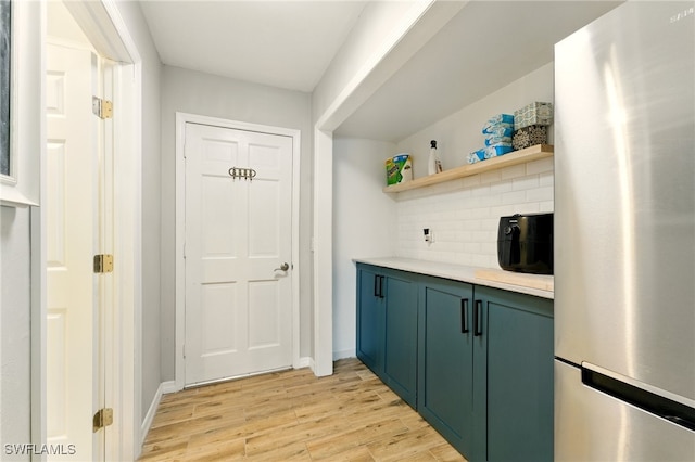 2491 43rd St SW, Naples, FL 34116 - bar with freestanding refrigerator, light wood-style floors, and backsplash