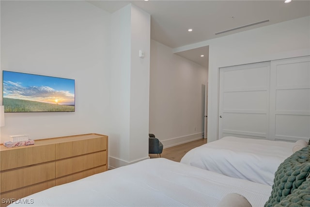 201 8th St S Unit 208, Naples, FL 34102 - bedroom featuring wood finished floors, recessed lighting, and a closet