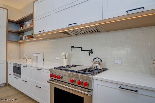 201 8th St S Unit 208, Naples, FL 34102 - kitchen featuring high end stove, backsplash, and light countertops