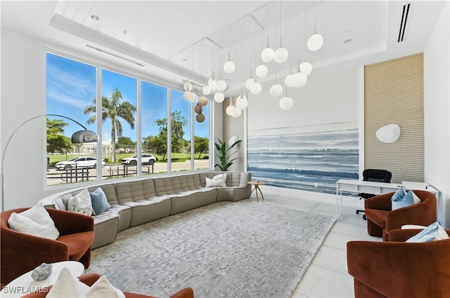 201 8th St S Unit 208, Naples, FL 34102 - living room featuring a tray ceiling, tile patterned flooring, and a wall of windows