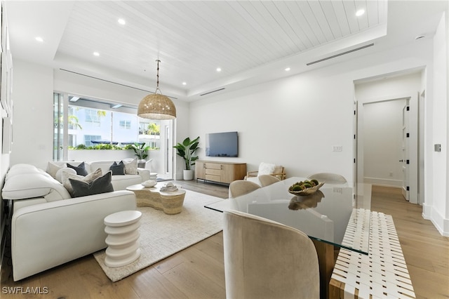 201 8th St S Unit 208, Naples, FL 34102 - living area with a tray ceiling, light wood-style floors, recessed lighting, and wooden ceiling