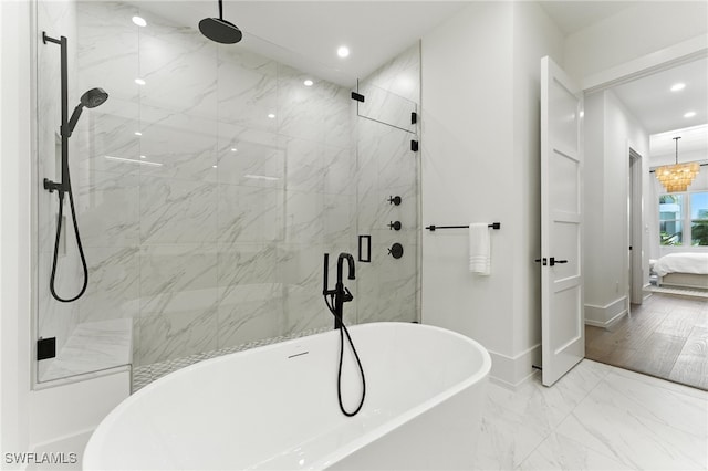 201 8th St S Unit 208, Naples, FL 34102 - ensuite bathroom with recessed lighting, a freestanding tub, a marble finish shower, and marble finish floors