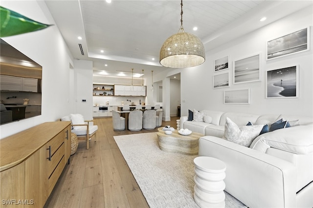 201 8th St S Unit 208, Naples, FL 34102 - living room with light wood-style floors, recessed lighting, and a tray ceiling
