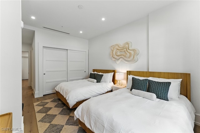 201 8th St S Unit 208, Naples, FL 34102 - bedroom with wood finished floors, recessed lighting, and a closet