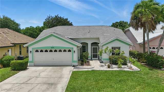 6643 Craven Hill Way, Naples, FL 34104 - mediterranean / spanish house with concrete driveway, stucco siding, a front lawn, and an attached garage