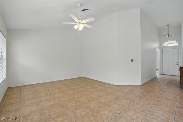 6643 Craven Hill Way, Naples, FL 34104 - empty room featuring high vaulted ceiling, a ceiling fan, a chandelier, and light tile patterned floors