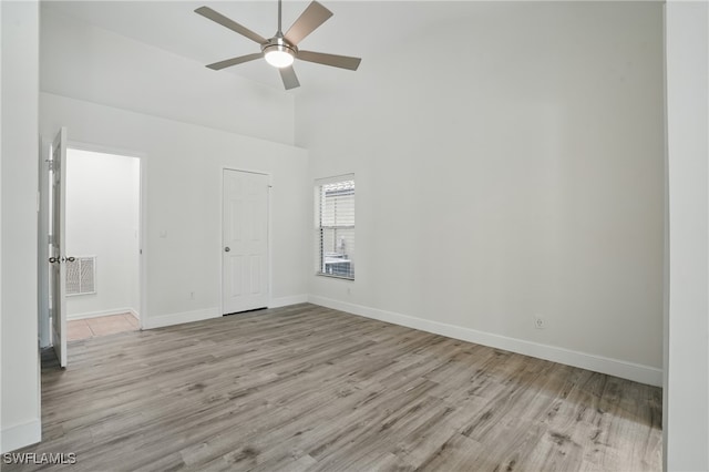 6643 Craven Hill Way, Naples, FL 34104 - unfurnished room featuring ceiling fan, wood finished floors, and a towering ceiling