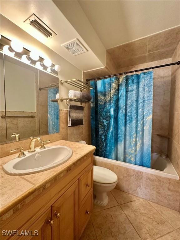 377 Vanderbilt Beach Rd Unit 103, Naples, FL 34108 - bathroom with tiled shower / bath, vanity, tile patterned floors, and tile walls