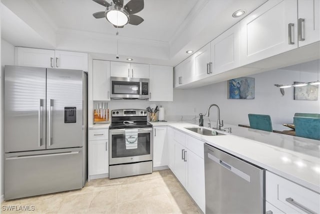6296 Sugar Bush Ln Unit C, Fort Myers, FL 33908 - kitchen featuring stainless steel appliances, ornamental molding, ceiling fan, white cabinetry, and light countertops