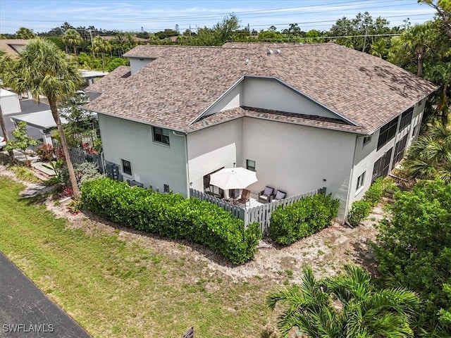 6296 Sugar Bush Ln Unit C, Fort Myers, FL 33908 - view of side of home featuring stucco siding and a shingled roof