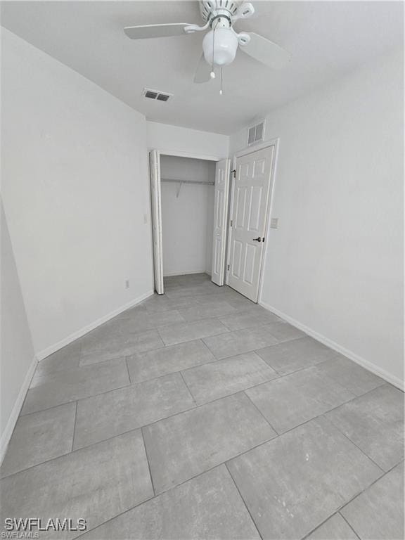 4520 19th St SW, Lehigh Acres, FL 33973 - unfurnished bedroom with light tile patterned floors, a closet, and a ceiling fan