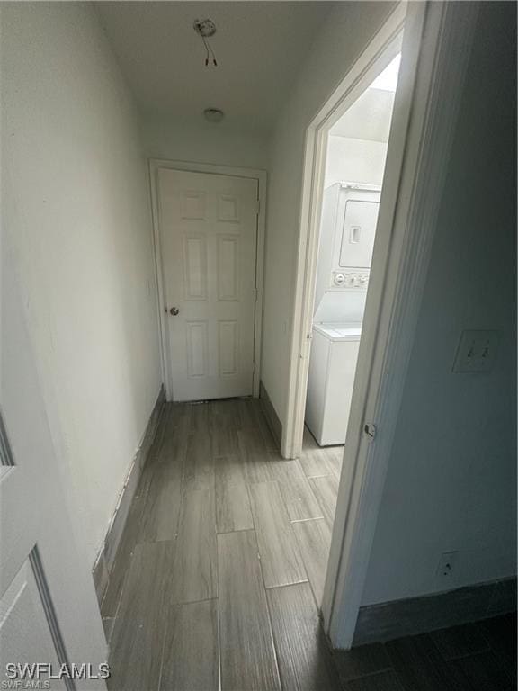 4520 19th St SW, Lehigh Acres, FL 33973 - hallway featuring stacked washer / dryer and light wood finished floors