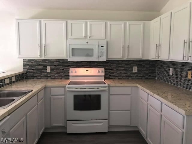 4520 19th St SW, Lehigh Acres, FL 33973 - kitchen with white appliances, white cabinets, and decorative backsplash